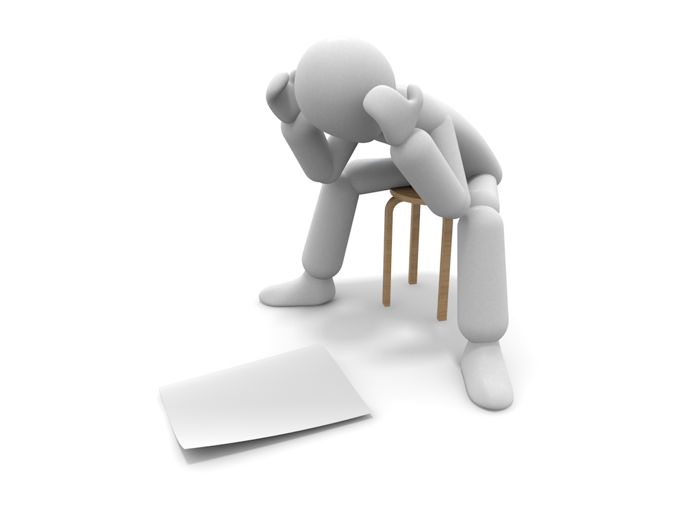 Illustration of a human figure sitting on a round stool, holding his head and staring at a white piece of paper