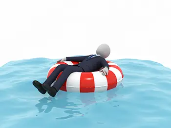 スーツを着たまま浮き輪を使って水面に浮かびリラックスしているビジネスマン