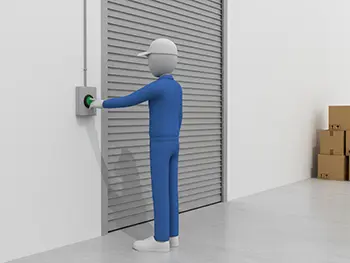 倉庫の壁にある緑色の押しボタンを指で押して、電動シャッターを操作している作業員のフリーイラスト