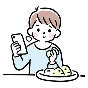 食事をしながらスマートフォンを見て驚く男の子の無料イラスト