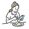 食事をしながらスマートフォンを真剣な表情で見る女性の無料イラスト