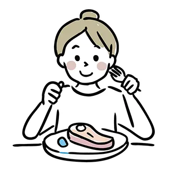 ナイフとフォークを使ってステーキを笑顔で食べる女性のフリー素材。