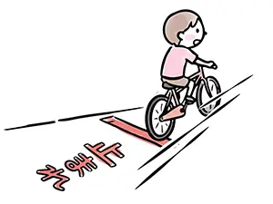自転車に乗った子供が道路の「止まれ」の文字と停止線を無視して走り抜けるイラスト