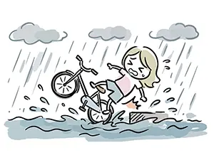 激しい雨の中、自転車に乗った女の子が大きな水たまりでスリップしてバランスを崩し転倒しているイラスト