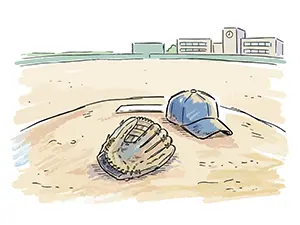 学校のグラウンドのマウンドの上に置かれた使い込まれた野球のグローブと帽子