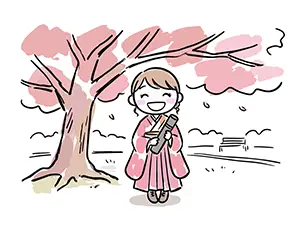 満開の桜の木の下で卒業証書の筒を持ち笑顔で立つ華やかな袴姿の女性